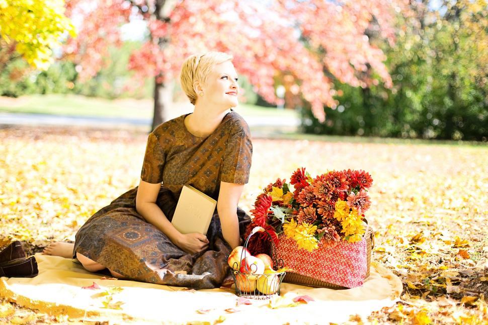 Free Image of Short Hair Woman With Book and Flowers - Looking Away  