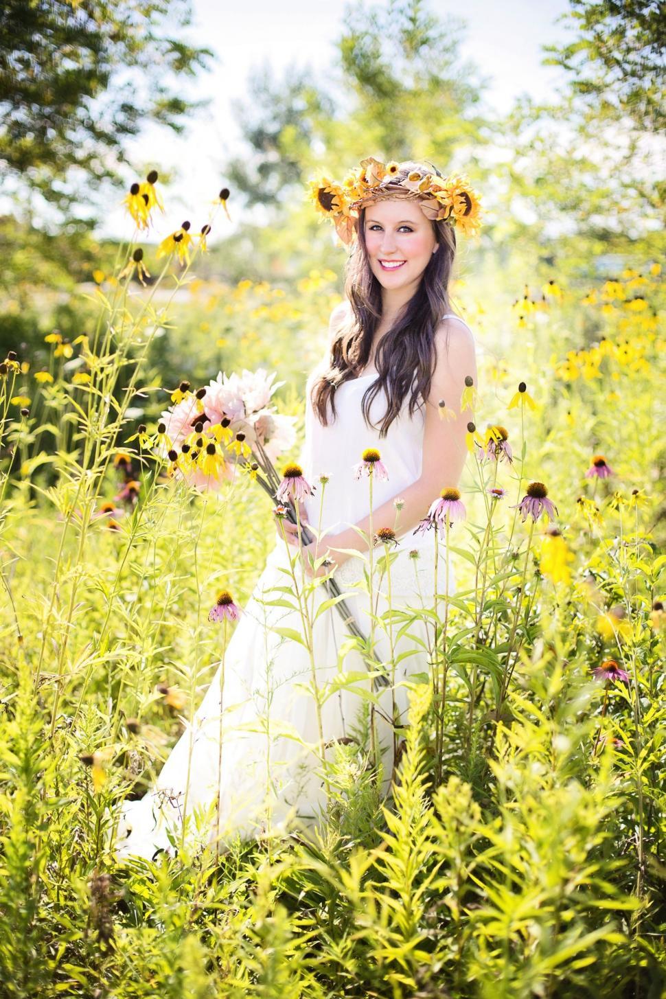 Free Image of Smiling Woman posing In sunflower crown - Looking at camera 