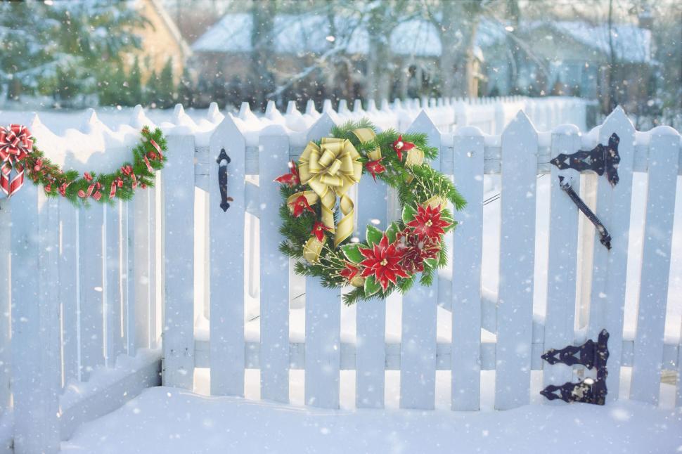 Free Image of Christmas Flower Decoration on Fence in Snow 