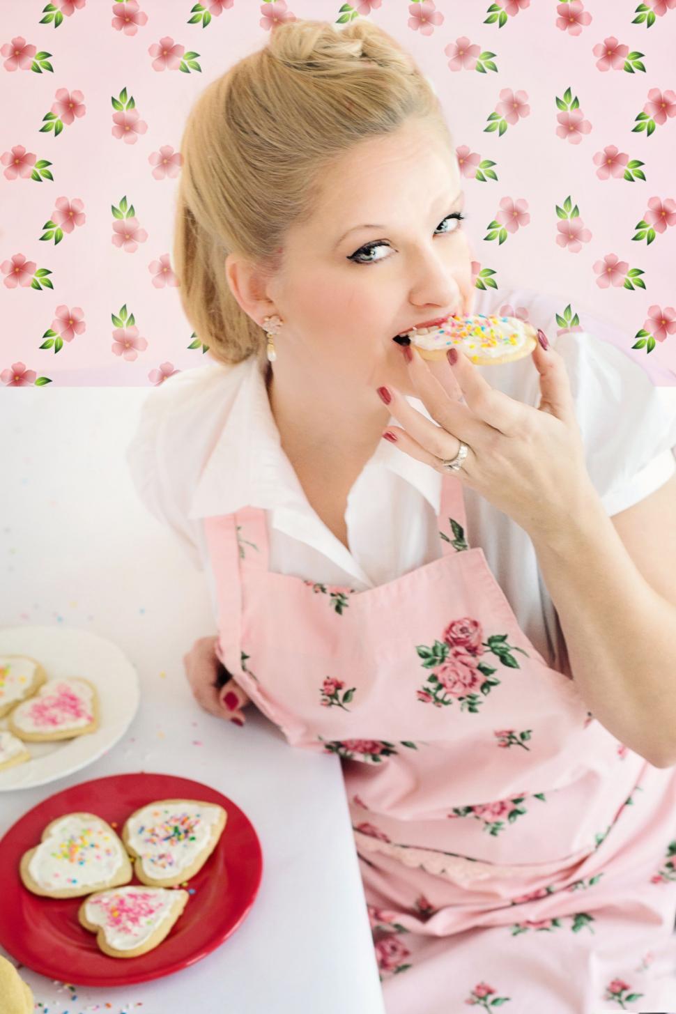 Free Image of Blonde Woman Nibbling Heart Shaped Cookies - Looking at camera  