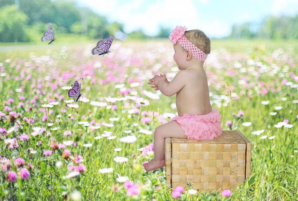 Free Image of Little Baby Girl And Butterflies in Flower Field 