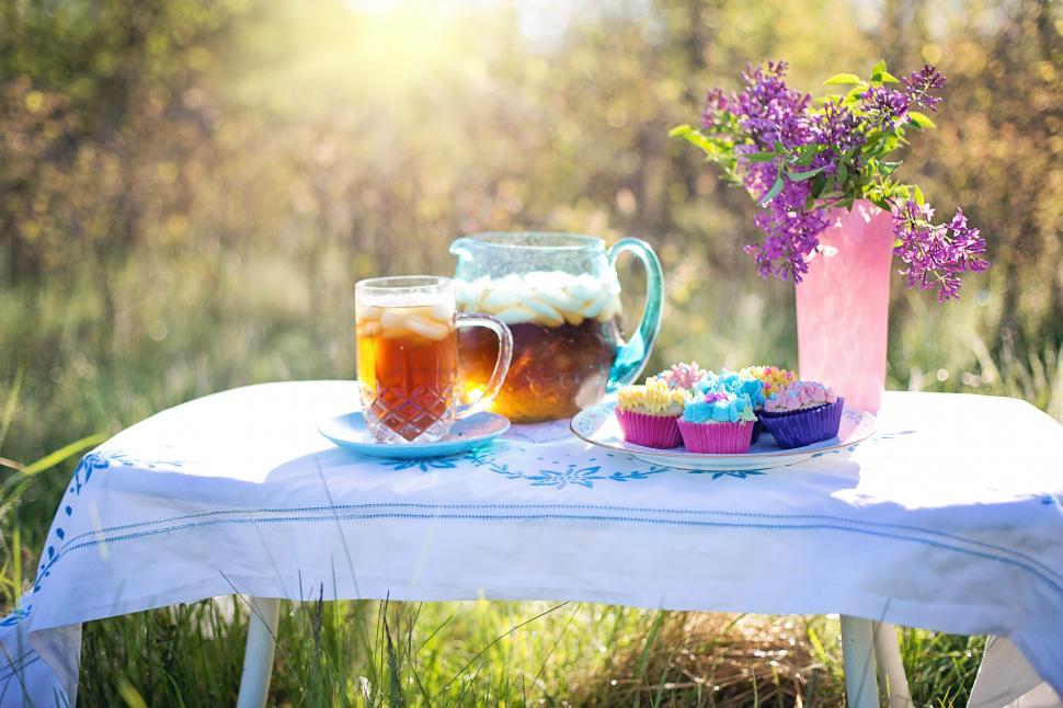 Free Image of Iced tea and Colorful Cupcakes in the garden 