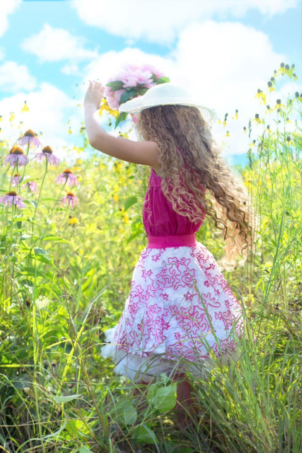 Free Image of Little Girl in hat in flower field 