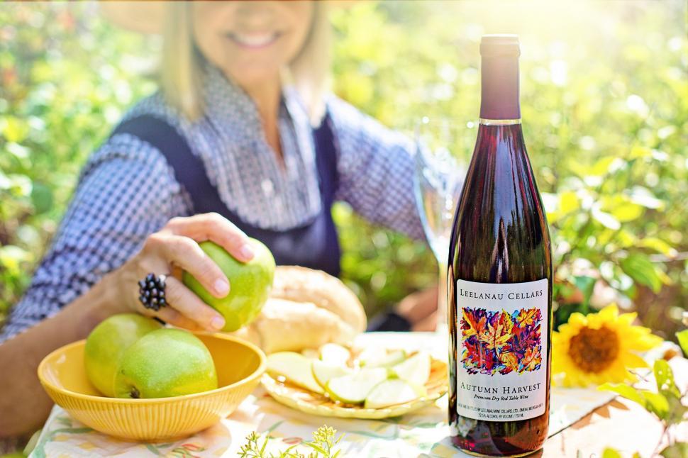 Free Image of Wine Bottle and Apples With Woman - Picnic 
