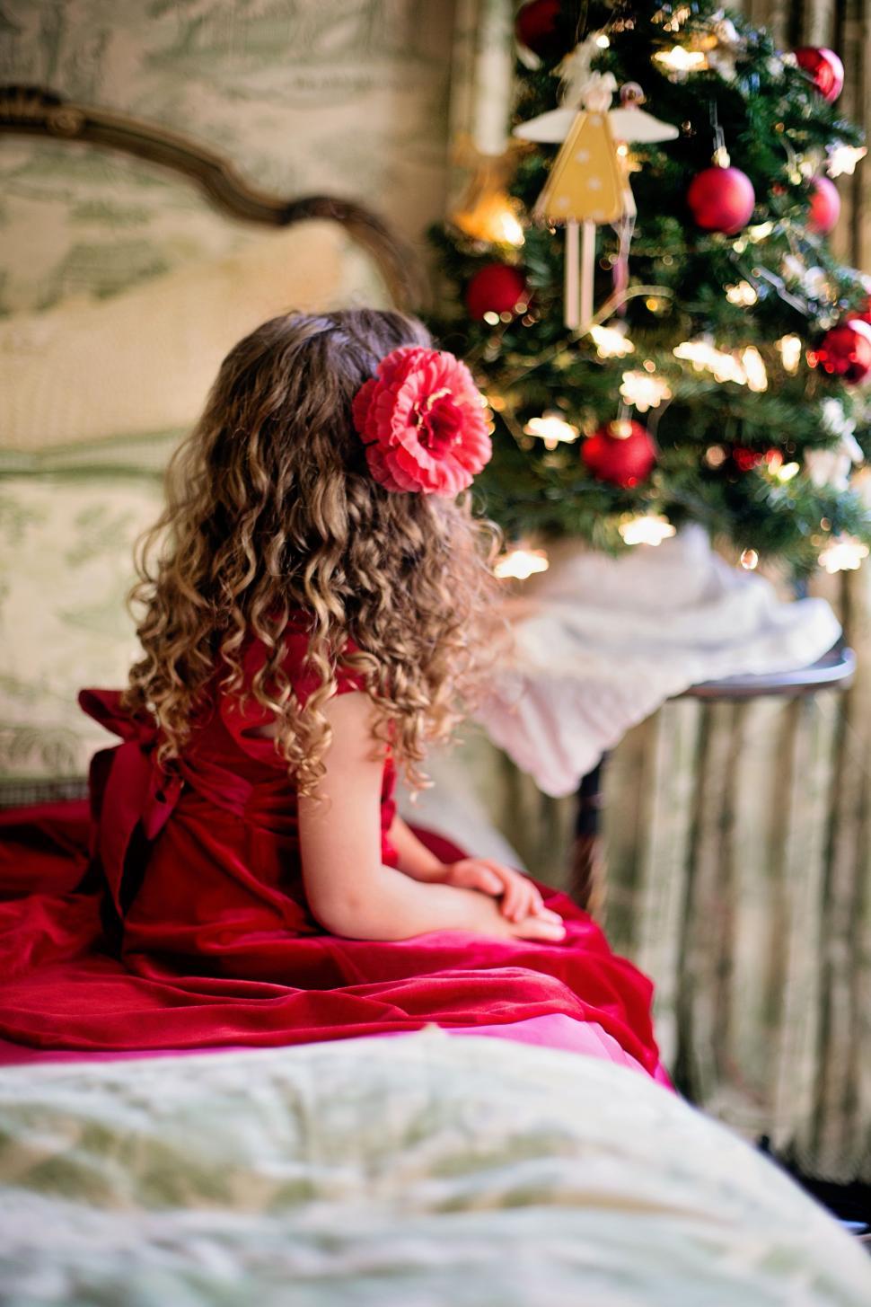 Free Image of Back view of little girl with Christmas lights 