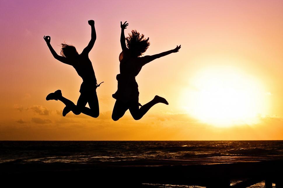 Free Image of People Jumping Against Sunset Sky  