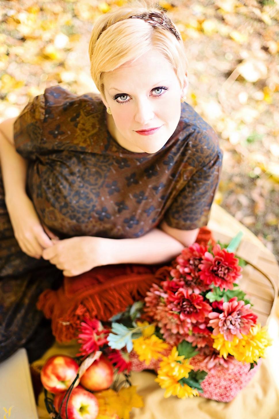 Free Image of Blonde Woman with basket of flowers - looking at camera 