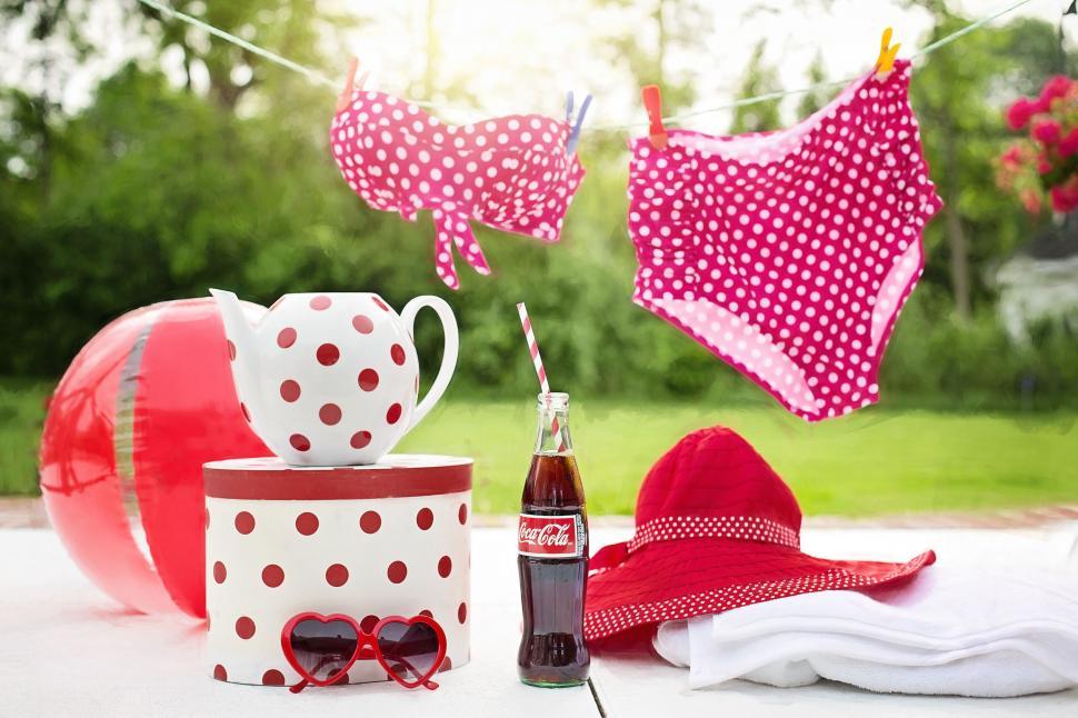 Free Image of Red polka dot bikini drying on the clothesline 