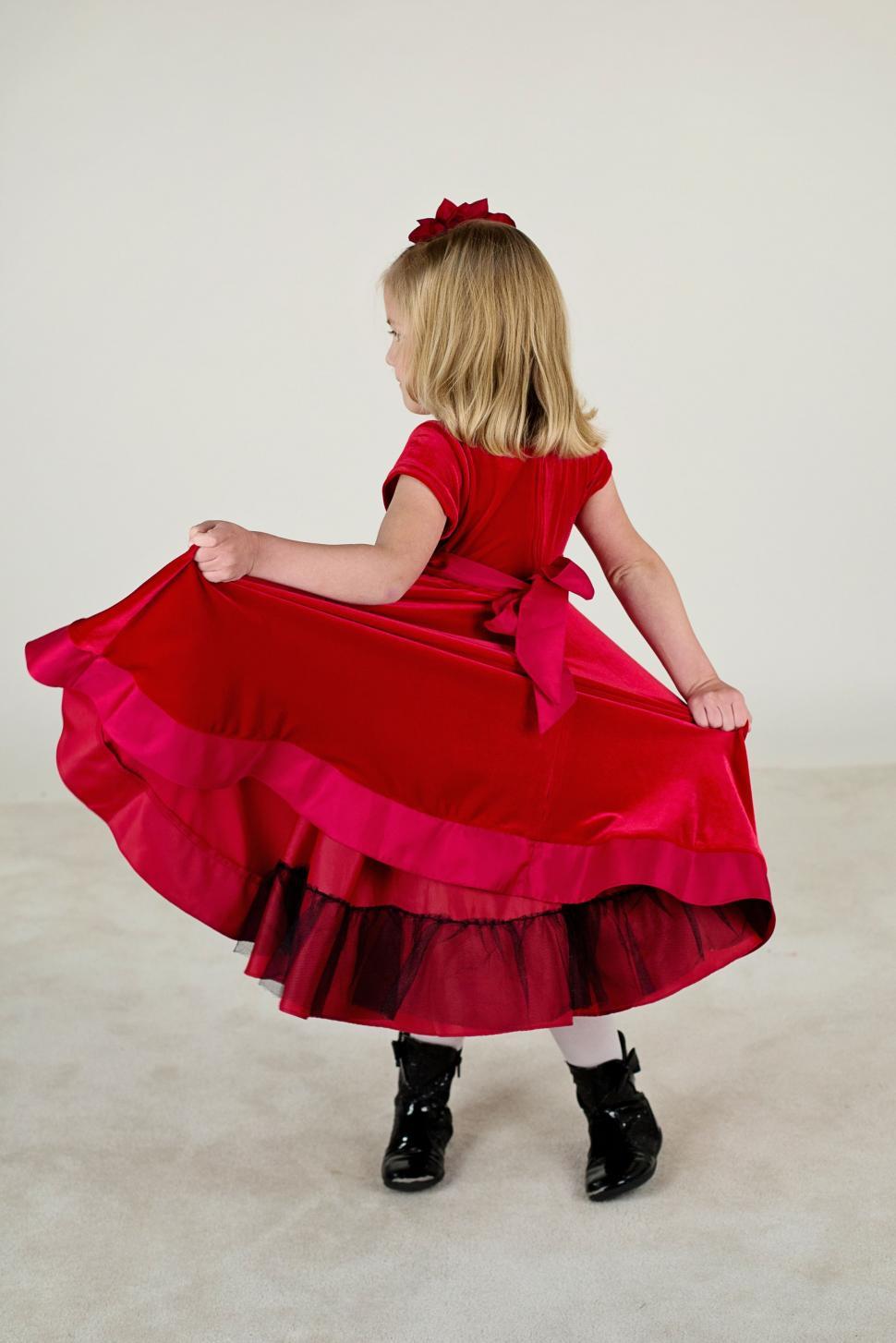 Free Image of Back view of little girl in red gown 