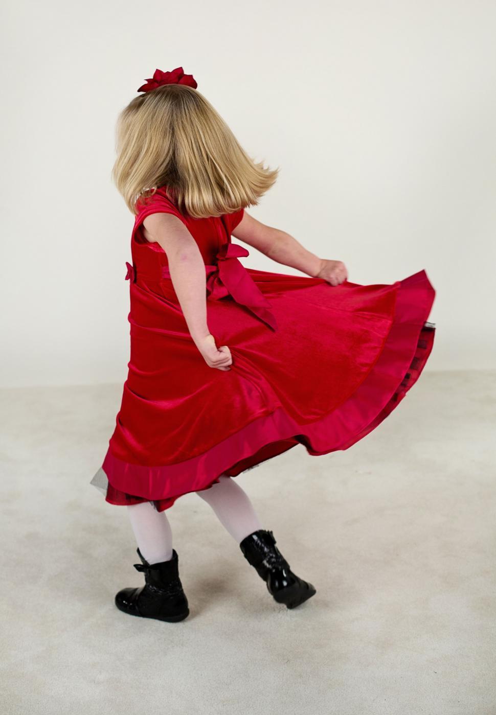 Free Image of Back view of little girl in red dress 