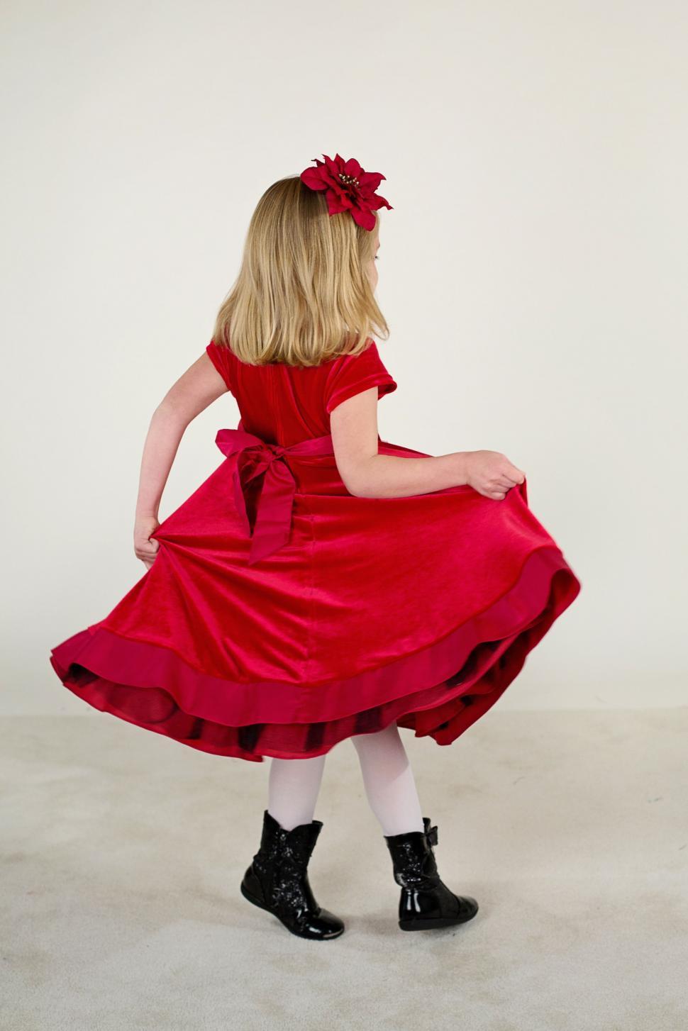 Free Image of Back view of little girl in red headband and red gown  