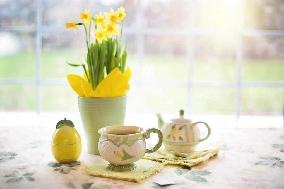 Free Image of Tea Cup and Yellow Flowers  
