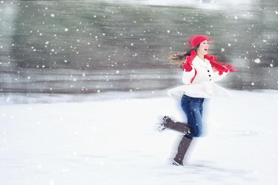 Free Image of Woman in red winter hat running in snow - Speed Effect 