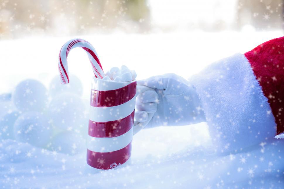 Free Image of Santa Hand and Coffee Mug in Snow  