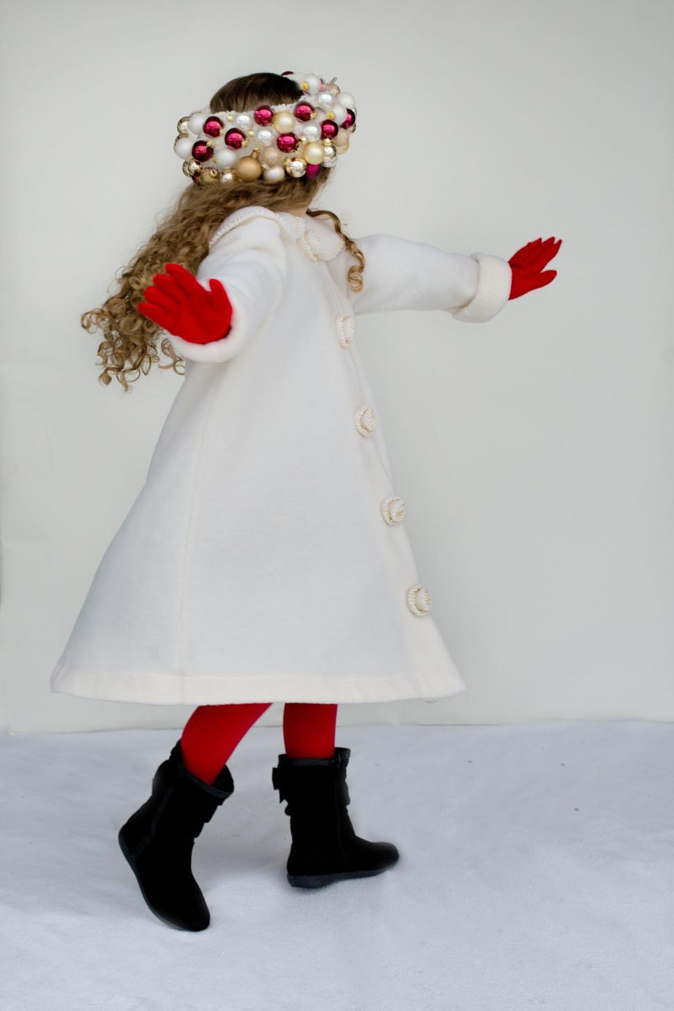 Free Image of Little girl in pearl headband with red gloves on white background 