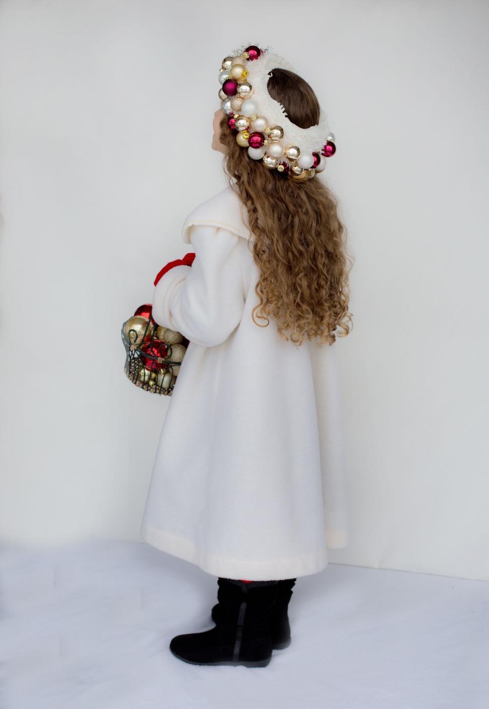 Free Image of Little girl in pearl headband and Christmas balls 