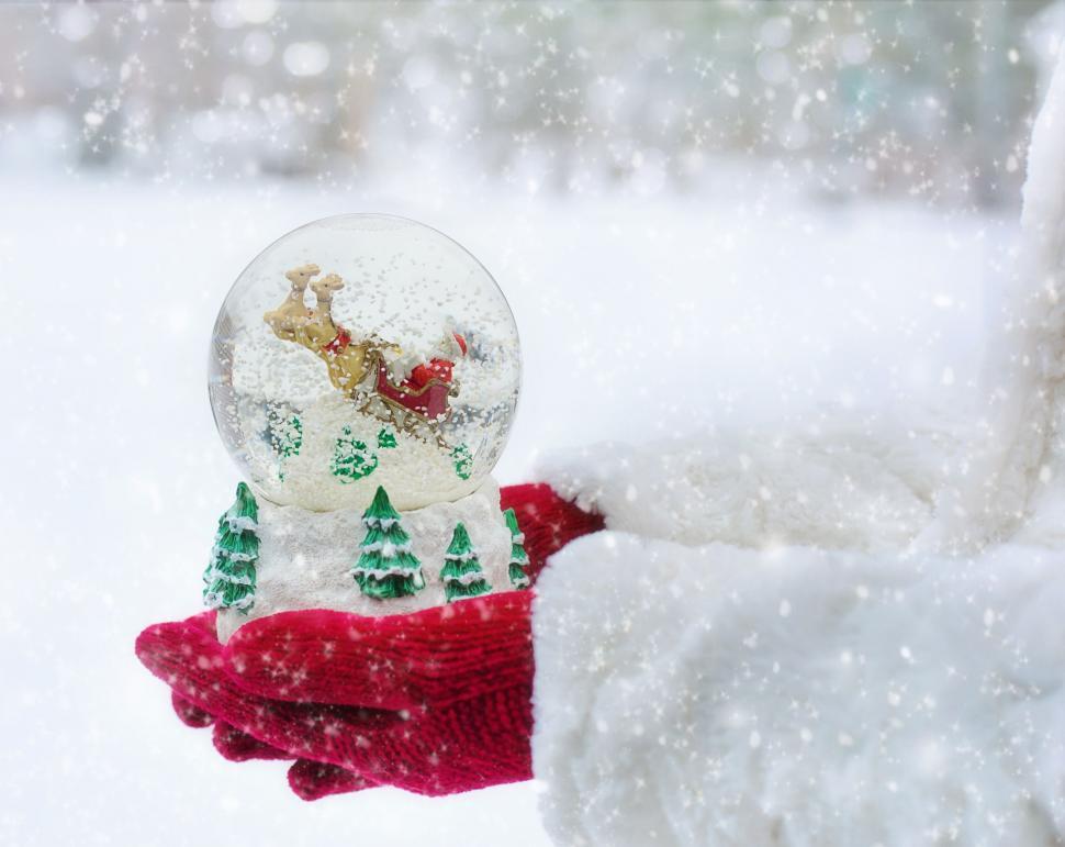 Free Image of Snow globe and hands in snow 