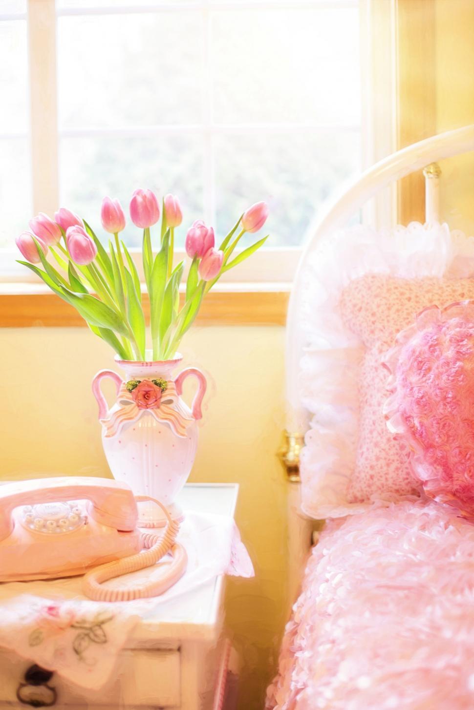 Free Image of Pink Flowers in Vase with Pink Bed and window 