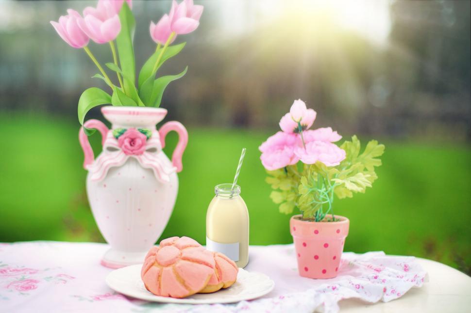 Free Image of Pastries with flowers on table in garden 