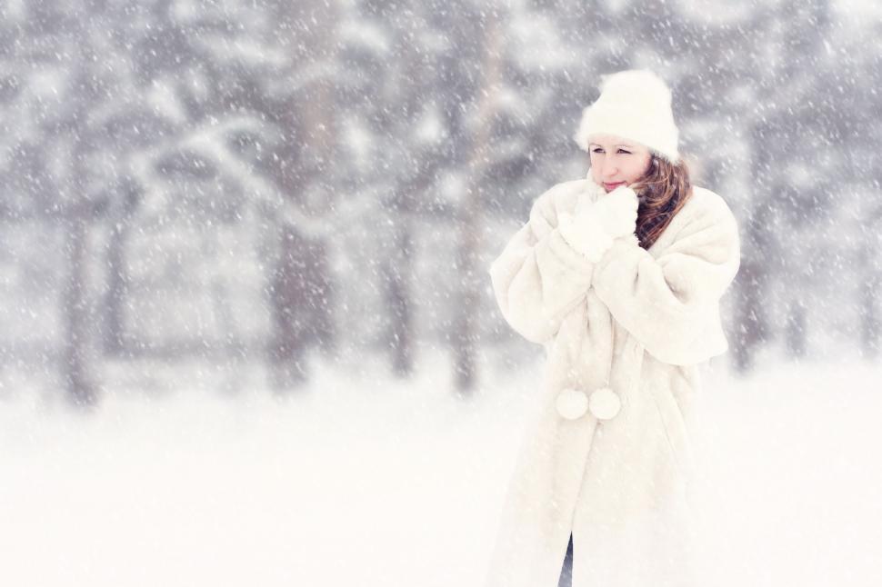 Free Image of Woman in White Hat Shivering in Snow 