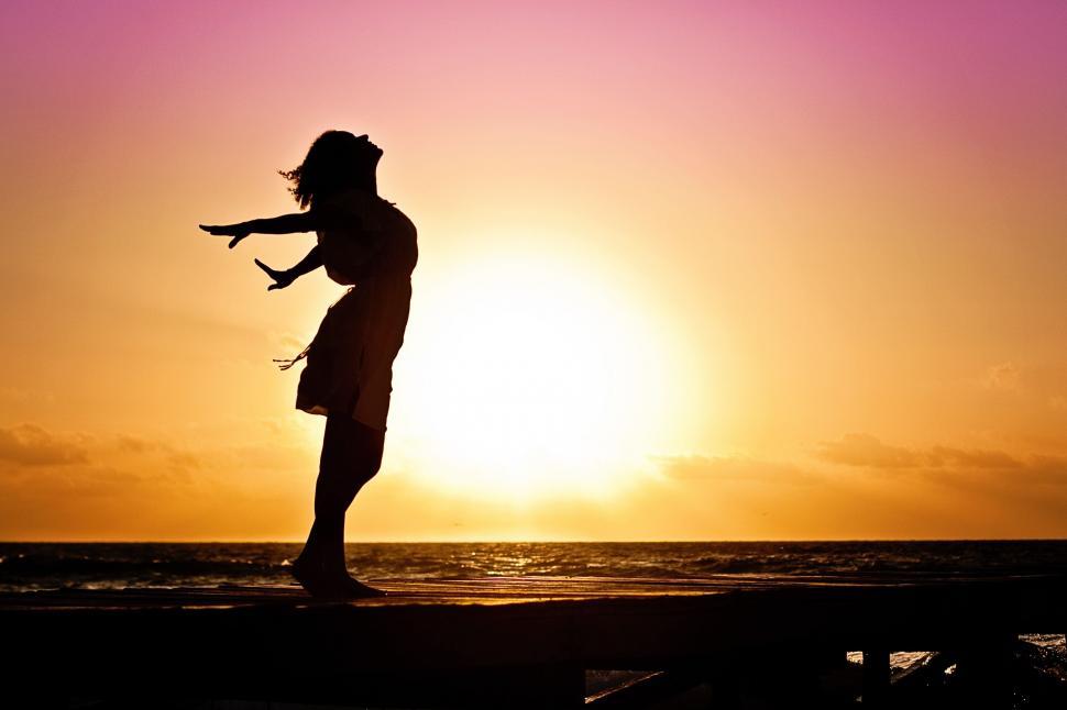 Free Image of Woman and Beach with Sunset  
