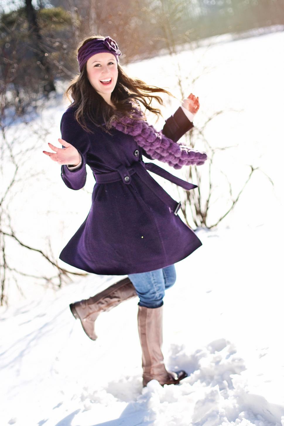 Free Image of Smiling Young Woman in Purple Winter Coat in Snow 