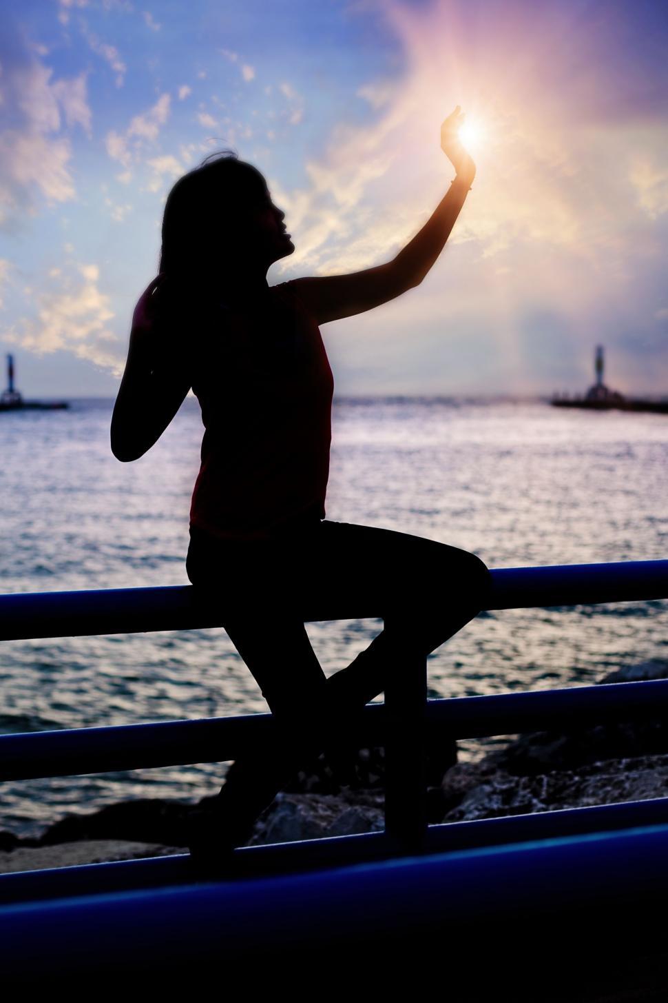Free Image of Woman and Sunset with Bridge 
