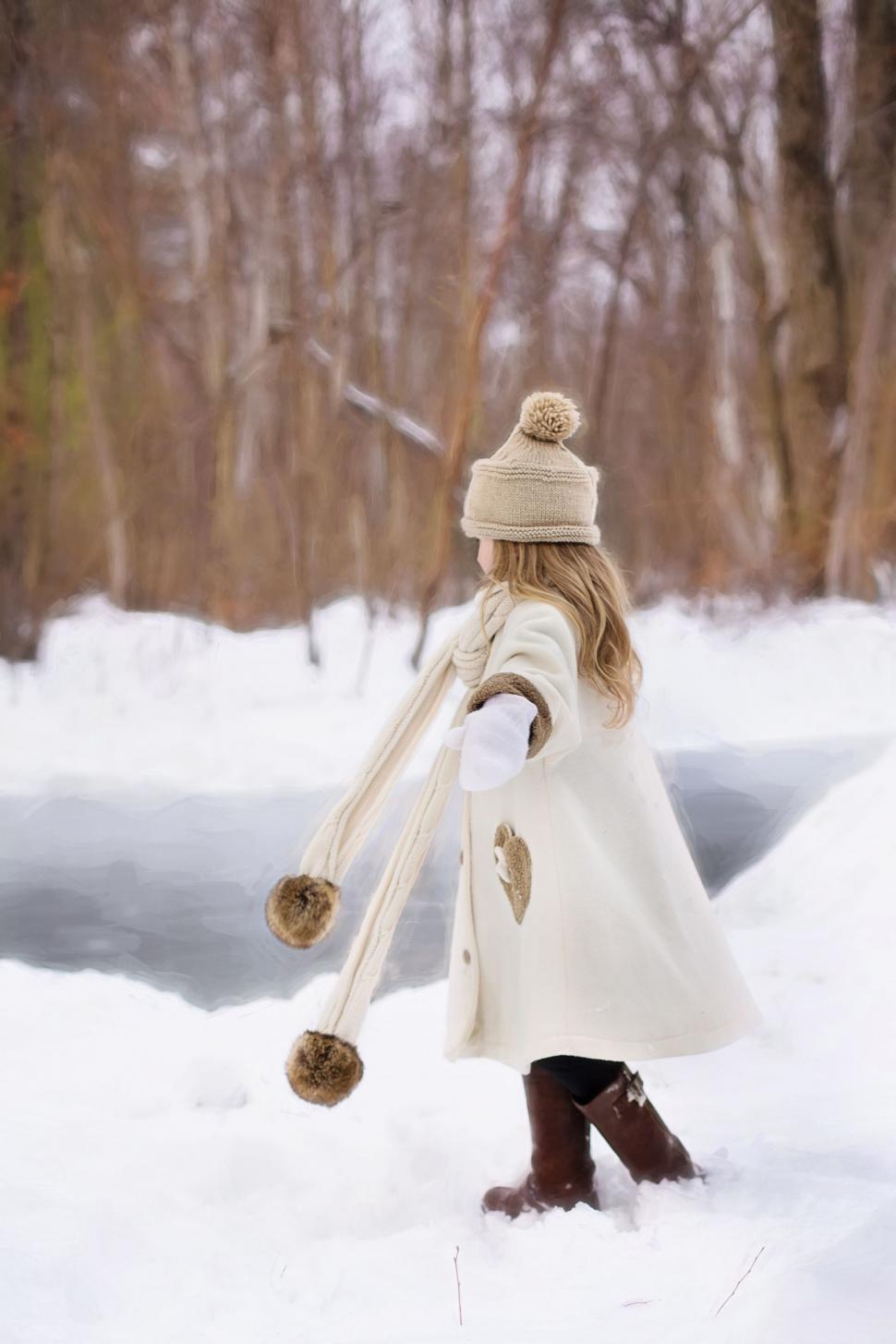 Free Image of Little girl in brown boots in snow  