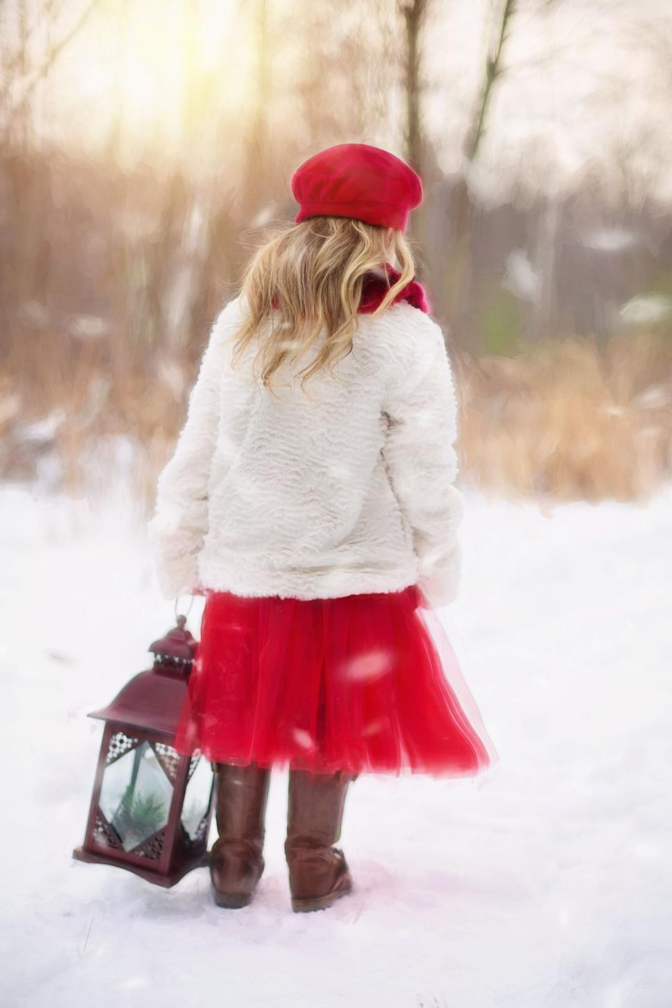 Free Image of Little Girl With Christmas lantern in Snow 
