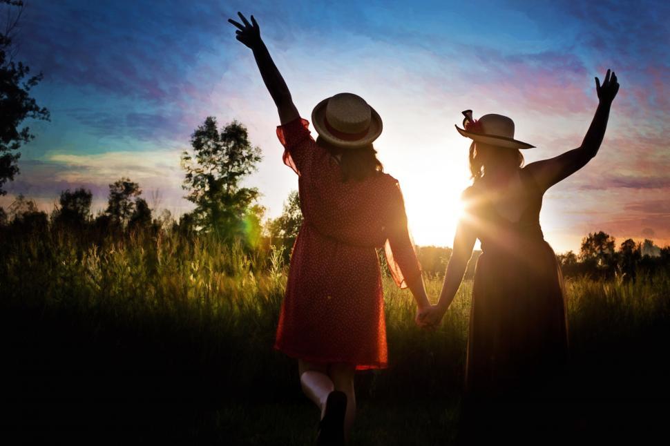 Free Image of Two Girls in hats with sunset 