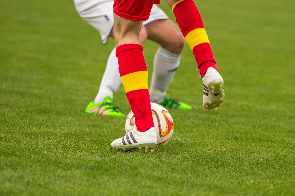 Free Image of Football players kicking a ball 