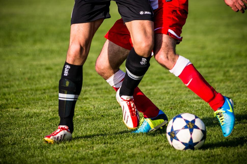 Free Image of Soccer players pushing each other for a ball 