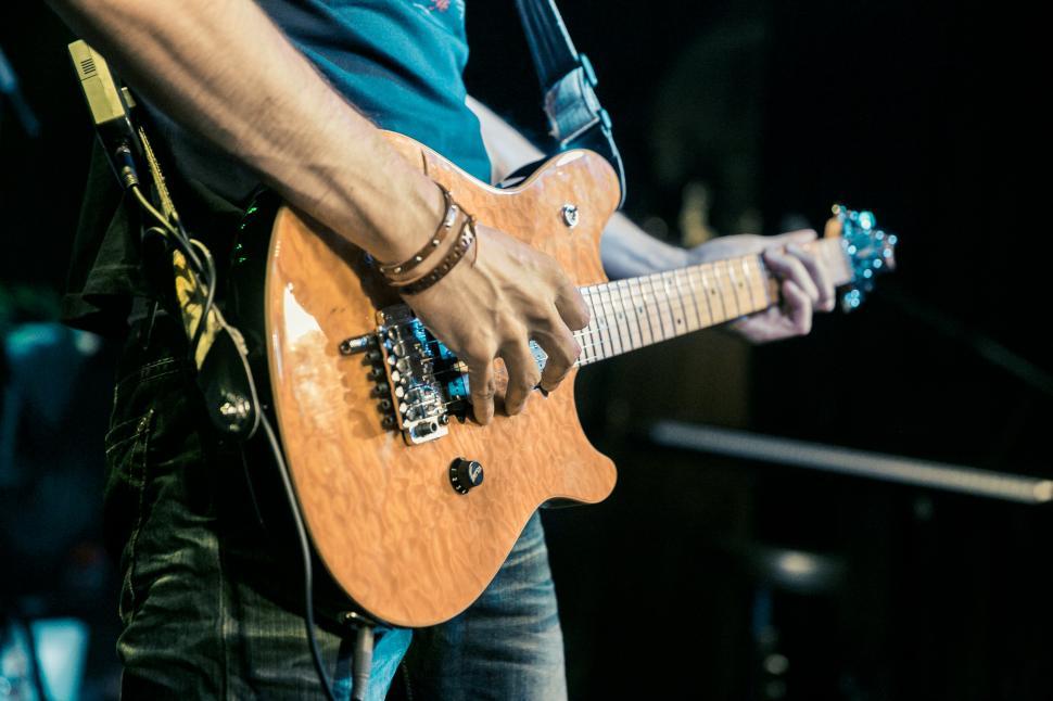 Free Image of Guitarist playing guitar on stage 