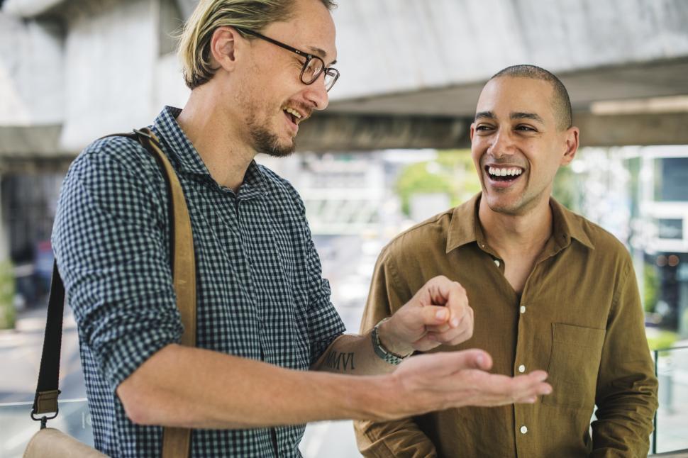 Free Image of Two smiling young men talking to each other 