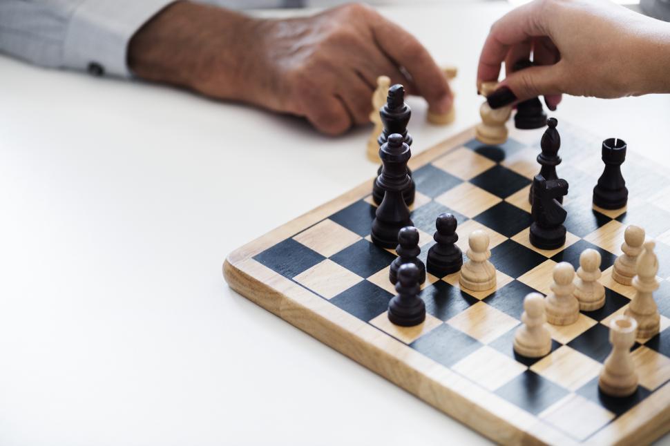 Free Image of Close up of people playing chess, small chess board 