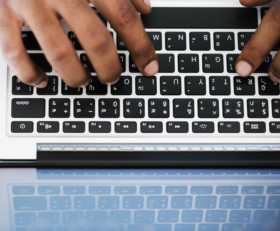 Free Image of A person s hands typing on laptop keyboard 