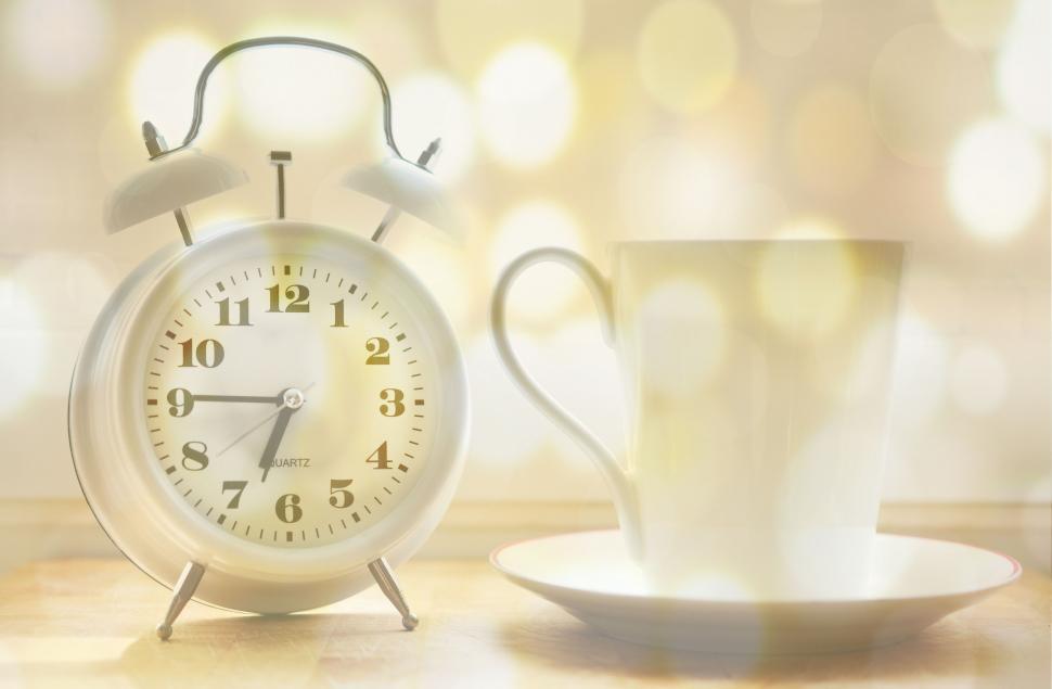 Free Image of Cup of Coffee and Table Clock 