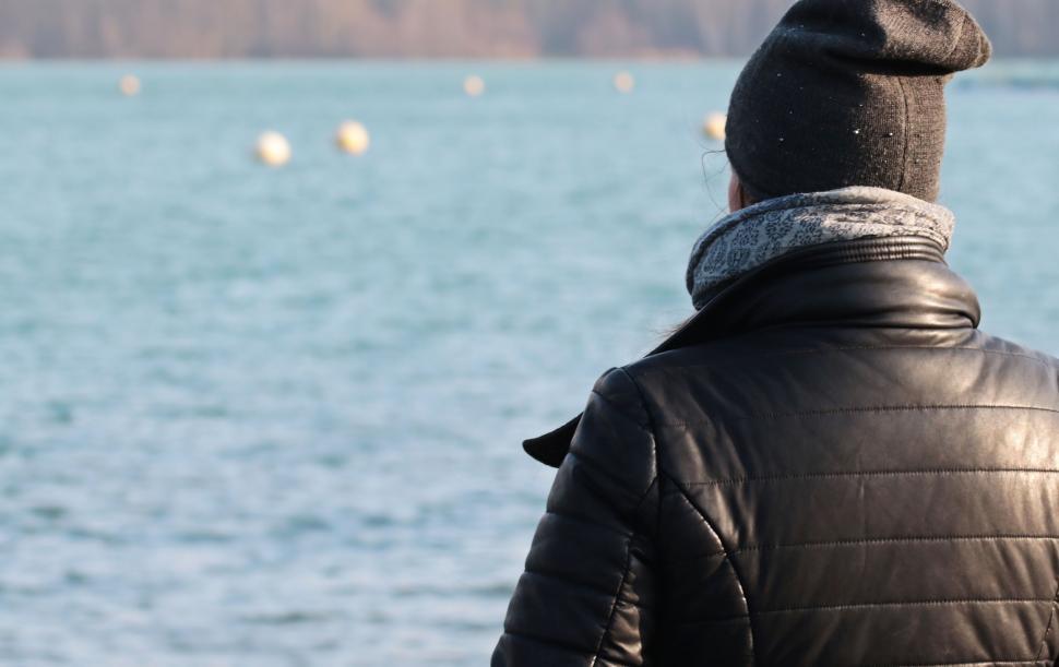Free Image of Back Side View of Woman in Beanie Cap at Lake 