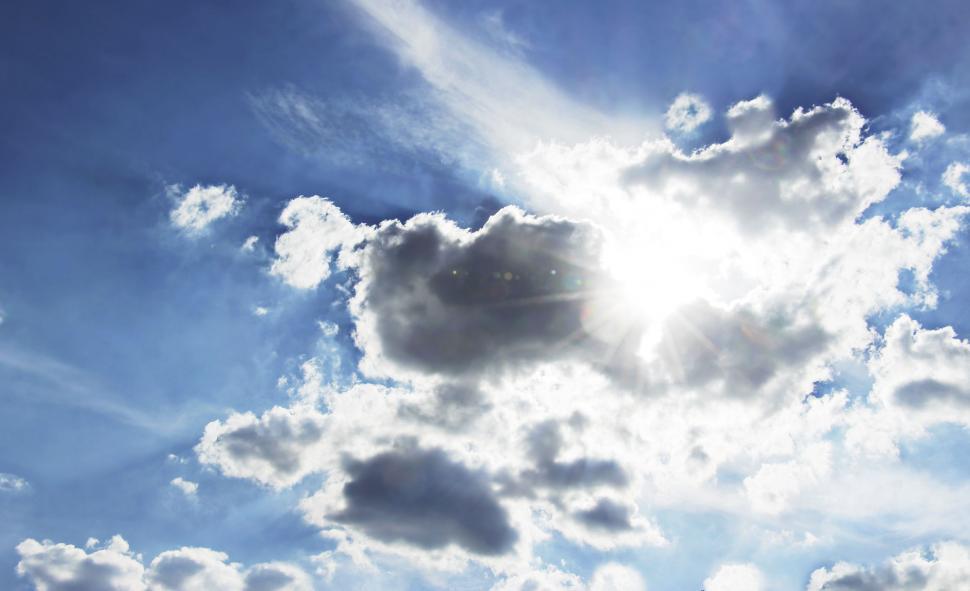 Free Image of White Clouds and Sunrays  