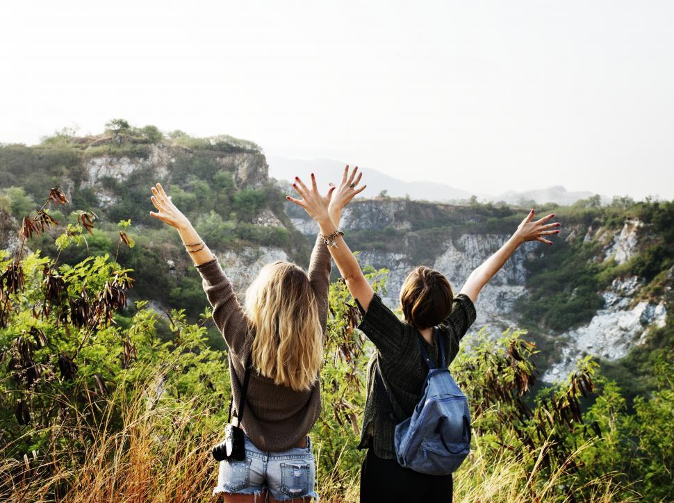 Free Image of Two young female hikers with their hands up 