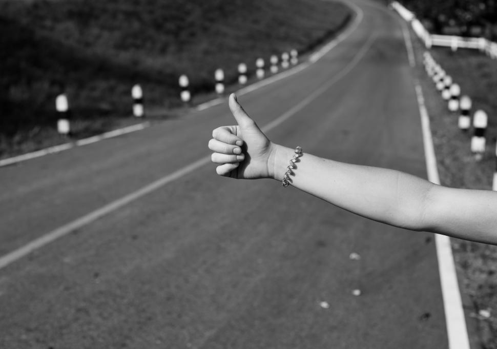 Free Image of A hand with thumbs up gesture asking permission for a lift - Hitchhiking 