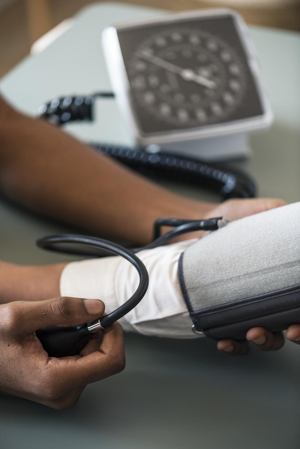 Free Image of Close up of a doctors hands monitoring blood pressure 