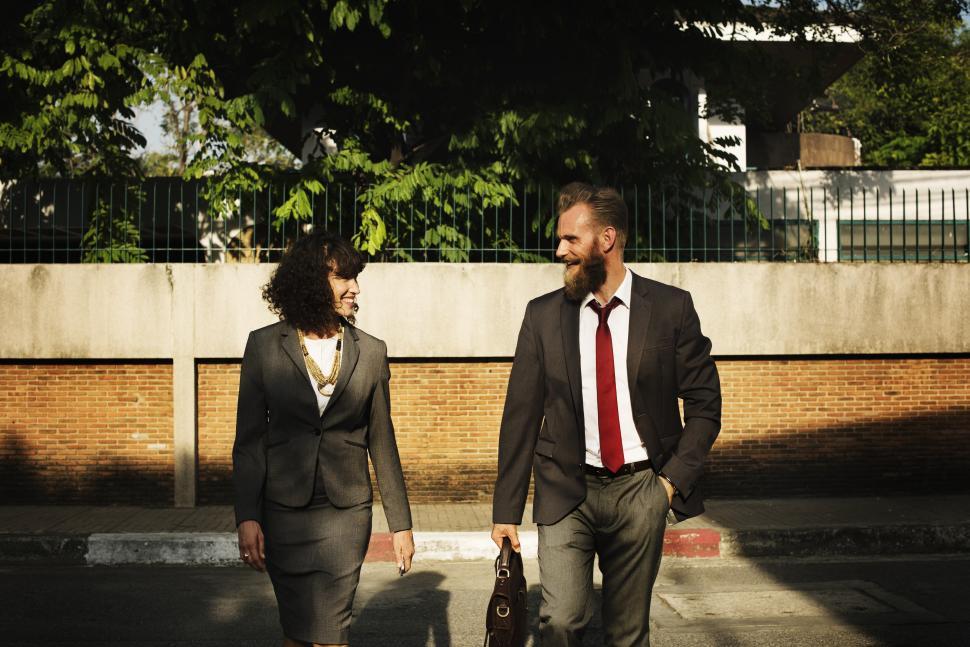 Free Image of Two business people conversing while taking a walk 