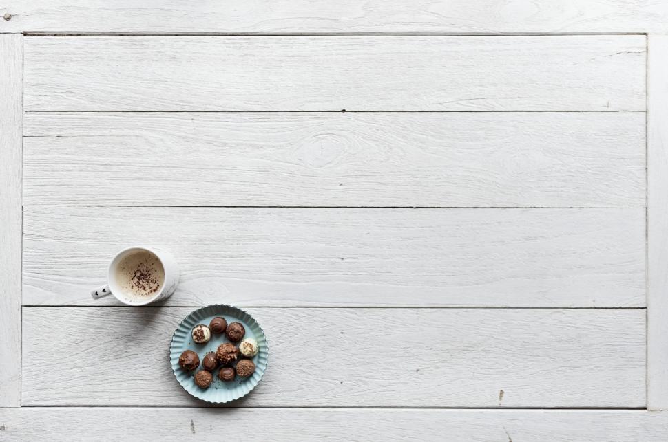 Free Image of Overhead view of a plate full of assorted chocolates and a coffee mug 