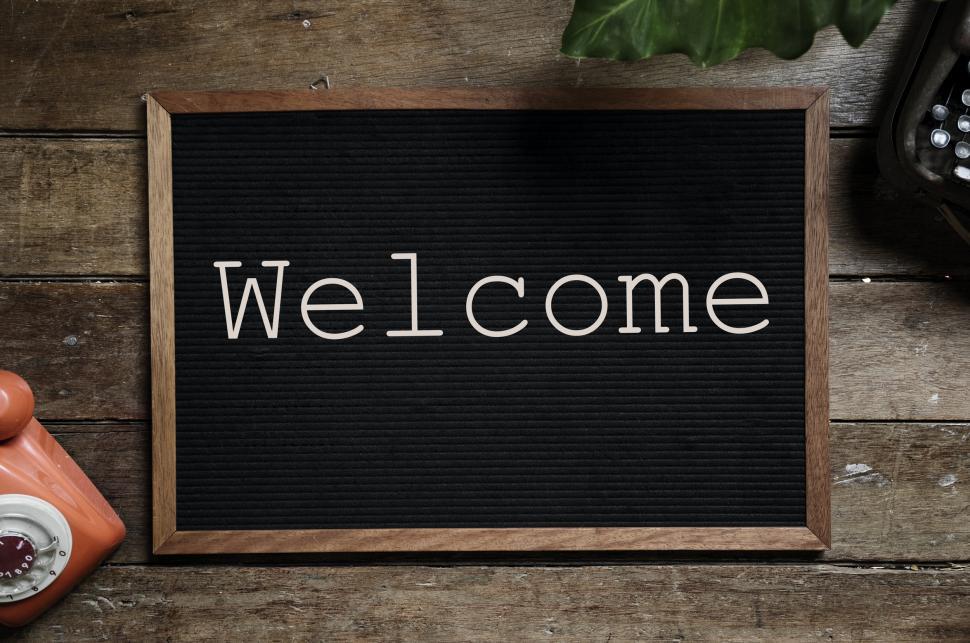 Free Image of Overhead view of text Welcome arranged on an old bulletin board 