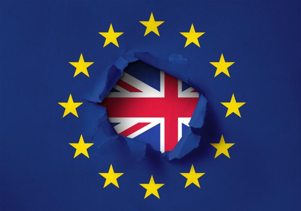 Free Image of Brexit concept created by a hole torn through the European Union paper flag 