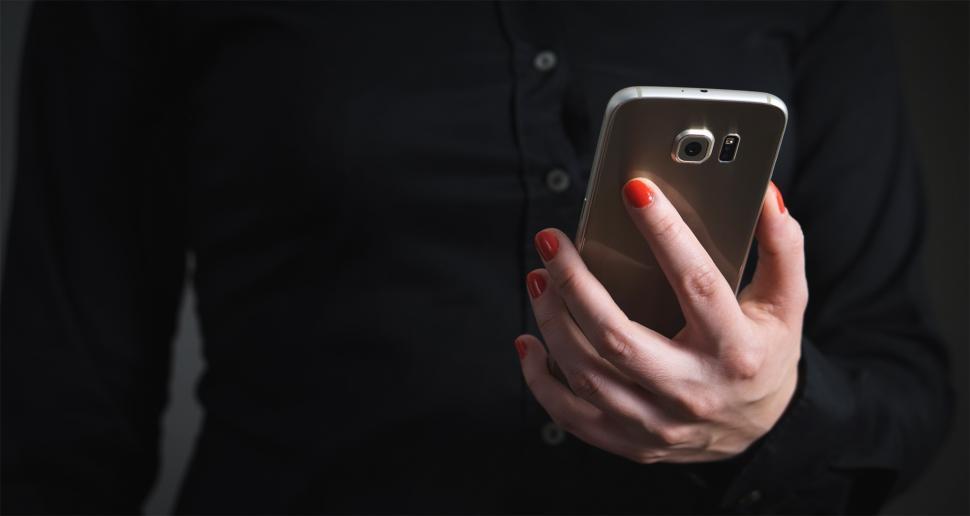 Free Image of Close up of a business person looking at mobile phone 