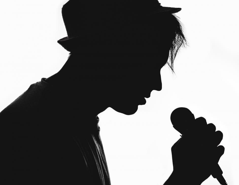 Free Image of Silhouette of a singer holding microphone 