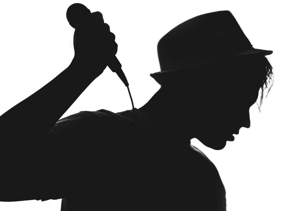 Free Image of Silhouette of a singer holding microphone 