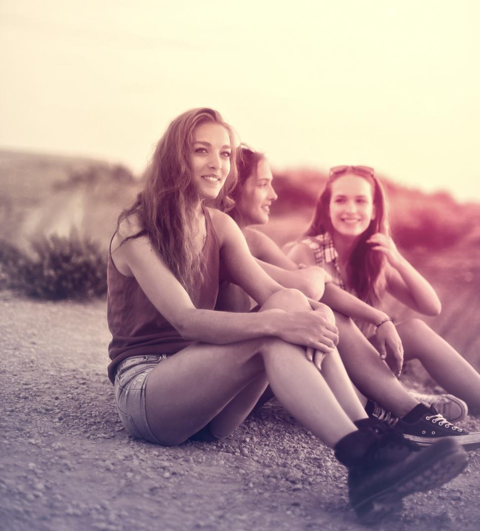 Free Image of Young Women Sitting on the Ground - Friendship 
